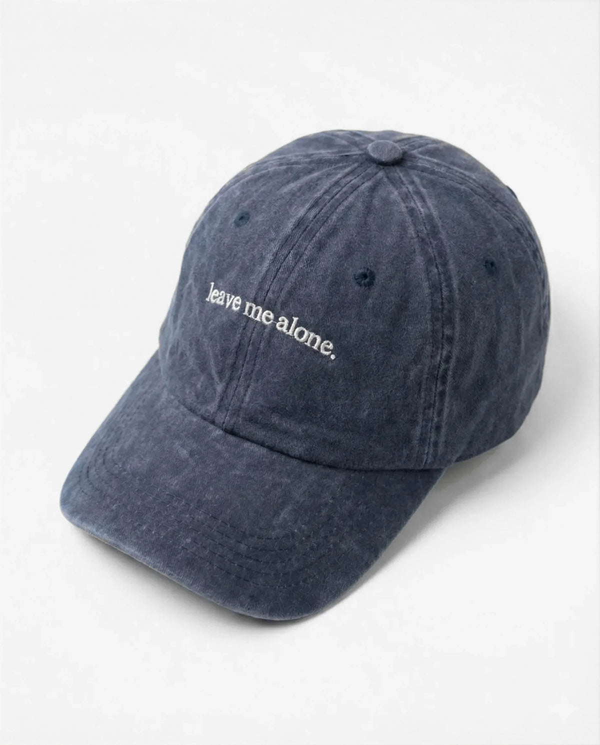 Leave me alone. dad hat in Blu navy, side view: embroidered 'leave me alone.' lettering, washed cotton