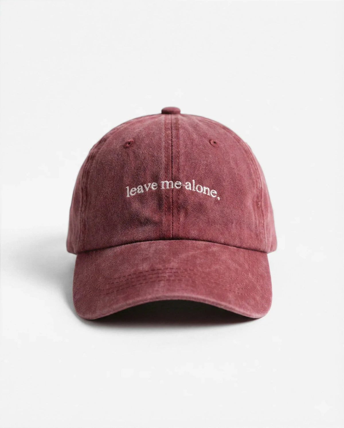 Leave me alone. dad hat in Burgundy, front view: embroidered 'leave me alone.' lettering, washed cotton