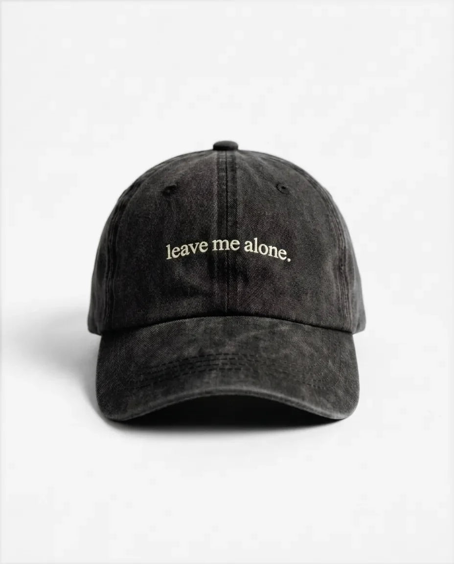 Leave me alone. dad hat in Black, front view: embroidered 'leave me alone.' lettering, washed cotton