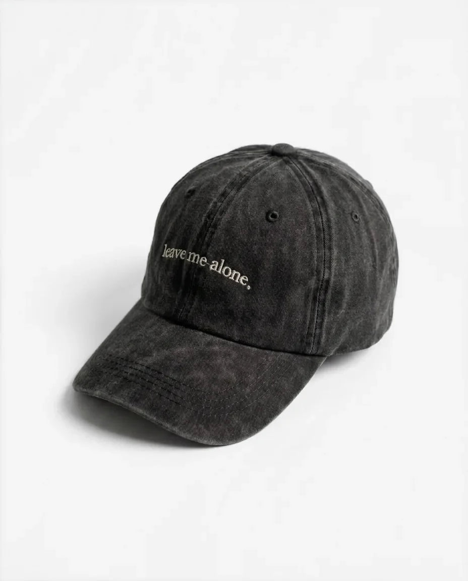 Leave me alone. dad hat in Black, side view: embroidered 'leave me alone.' lettering, washed cotton