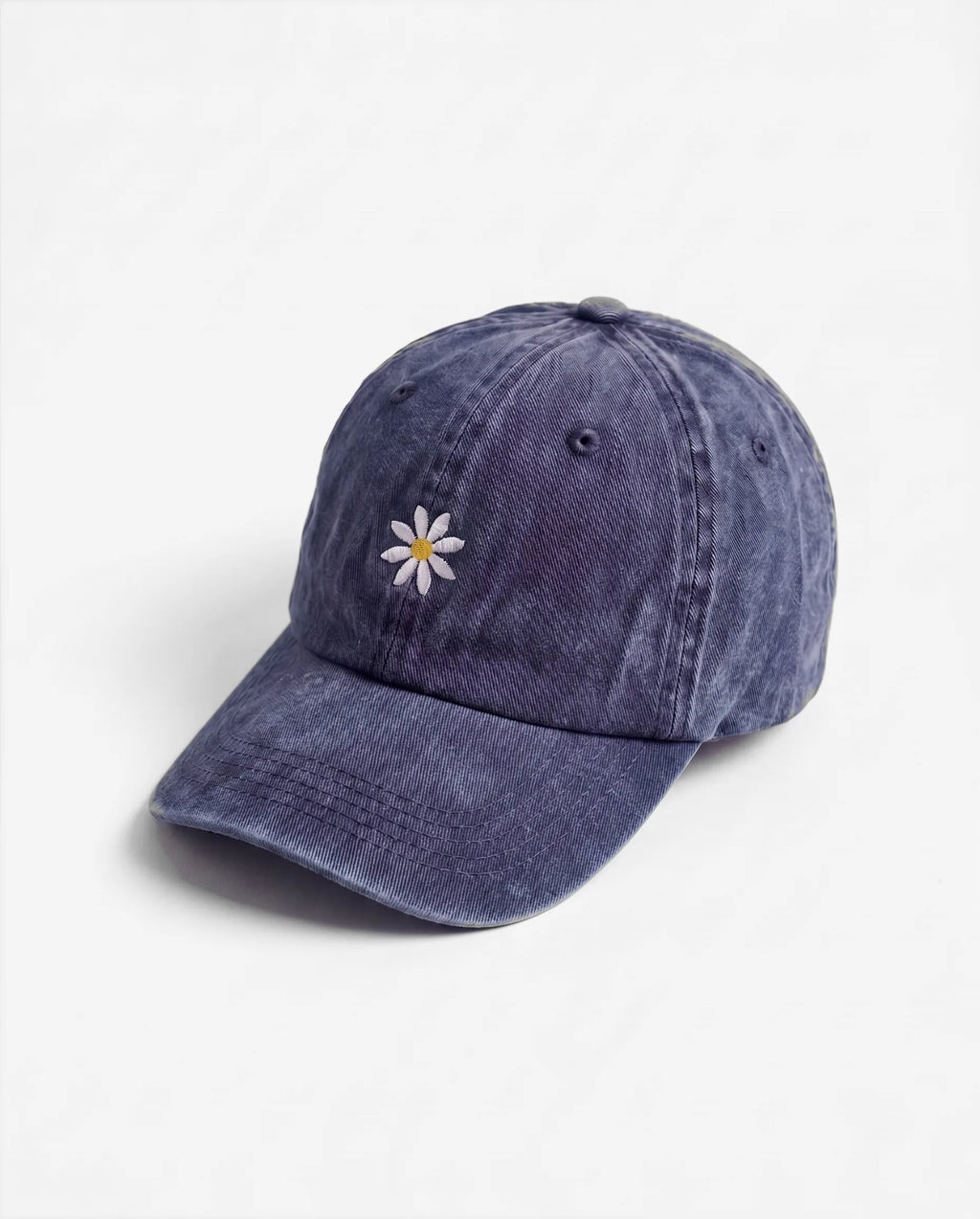 The Daisy dad hat in Blu navy, side view: embroidered daisy, washed cotton