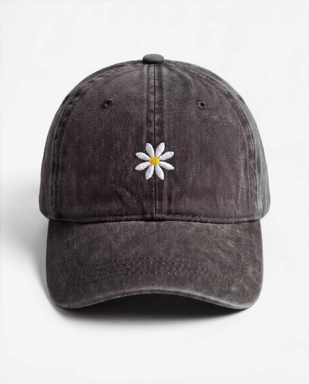 The Daisy dad hat in Black, front view: embroidered daisy, washed cotton