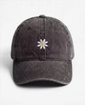 The Daisy dad hat in Black, front view: embroidered daisy, washed cotton