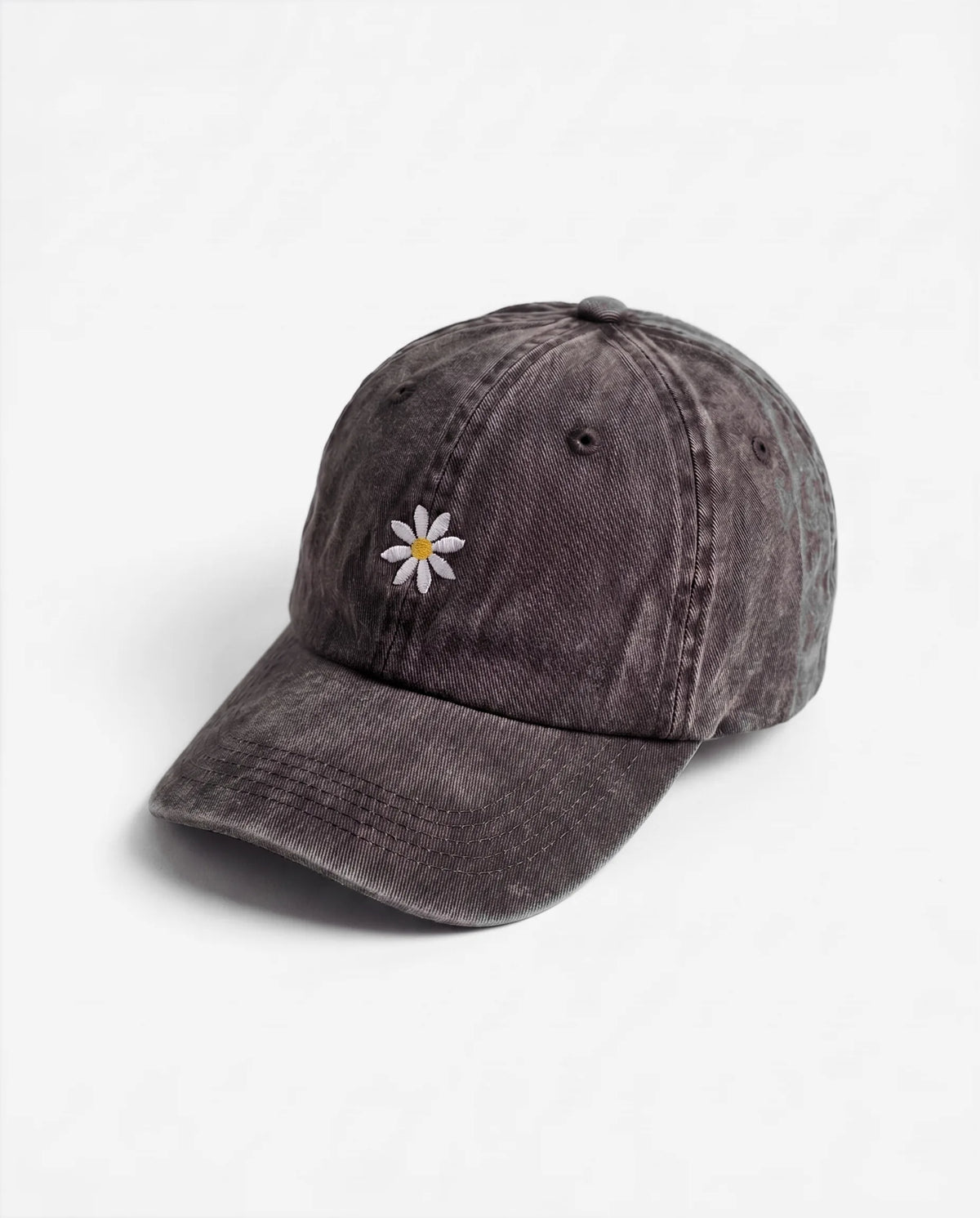 The Daisy dad hat in Black, side view: embroidered daisy, washed cotton