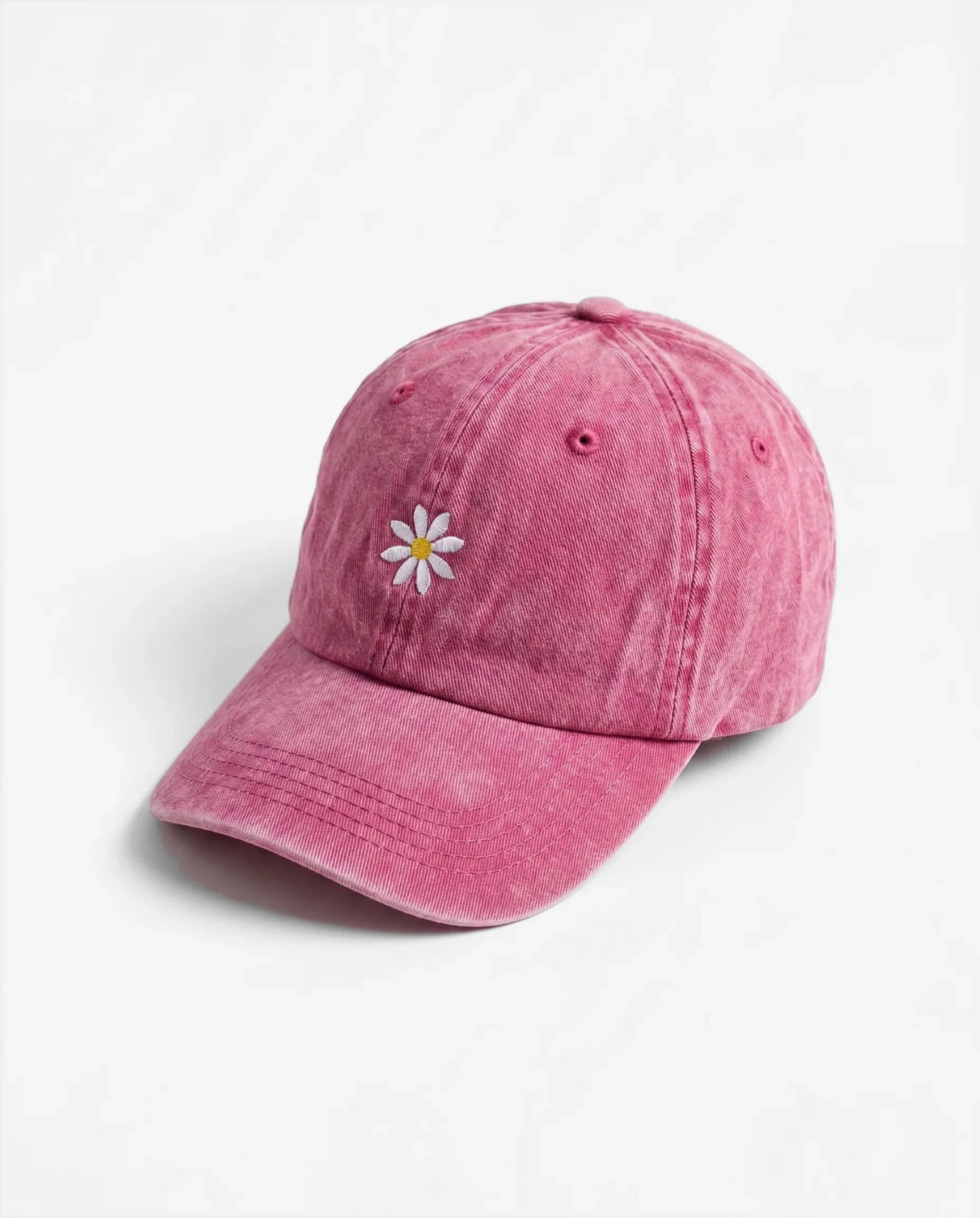 The Daisy dad hat in Rose, side view: embroidered daisy, washed cotton