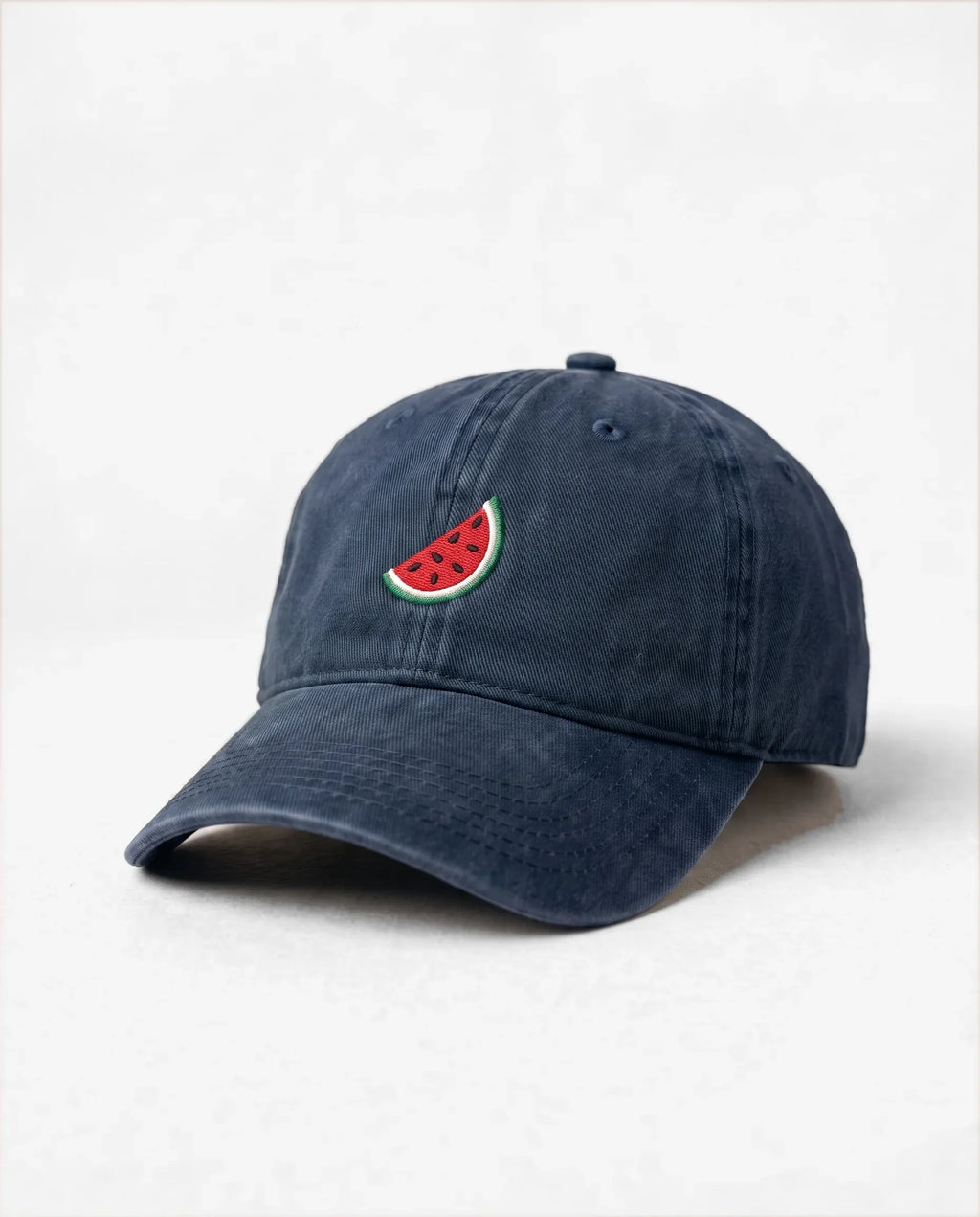 Watermelon dad hat in Blu navy, three-quarter view: embroidered watermelon slice, washed cotton
