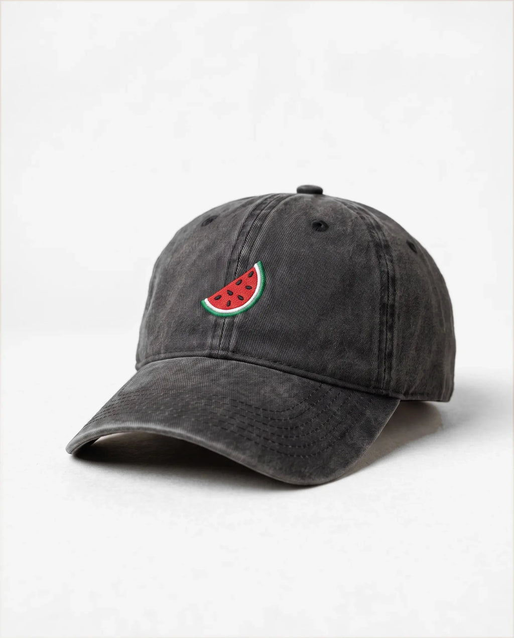 Watermelon dad hat in Black, three-quarter view: embroidered watermelon slice, washed cotton