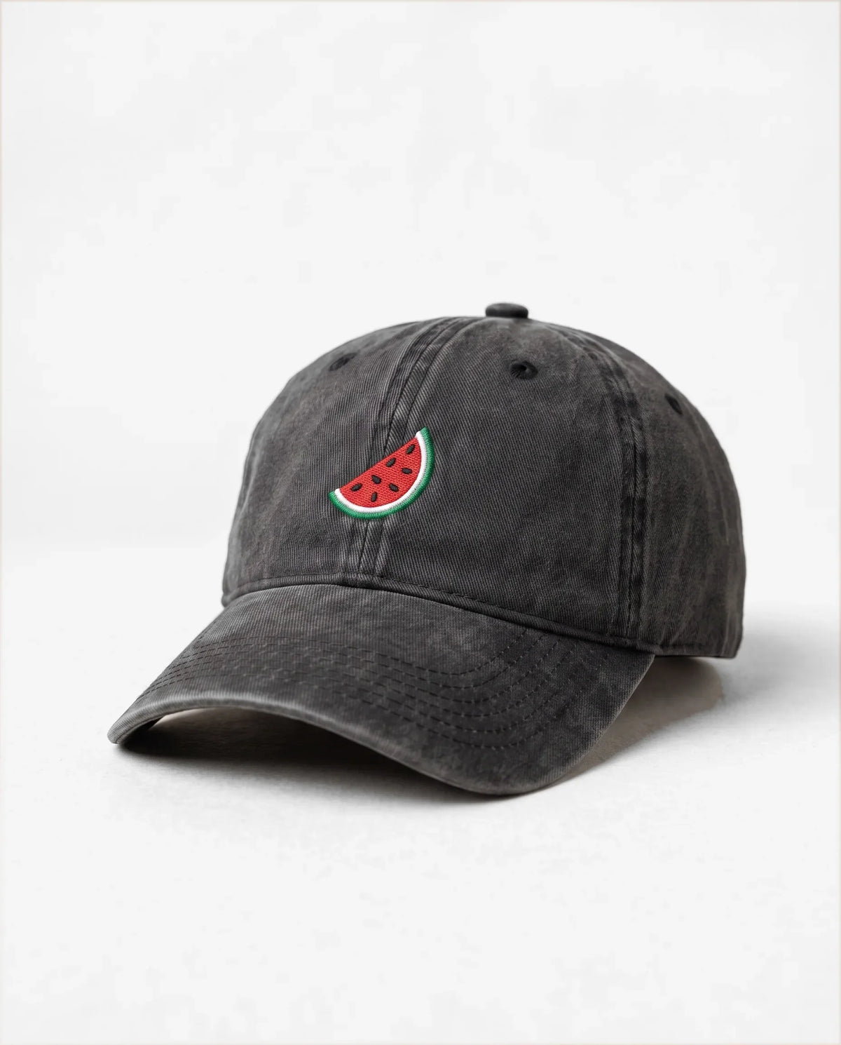 Watermelon dad hat in Black, three-quarter view: embroidered watermelon slice, washed cotton