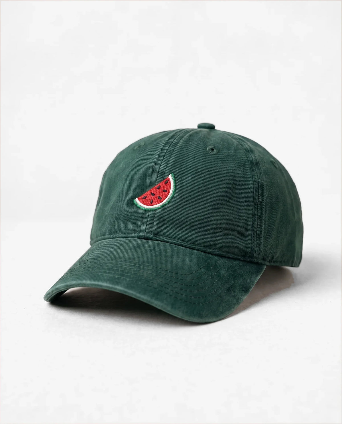 Watermelon dad hat in Emerald Green, three-quarter view: embroidered watermelon slice, washed cotton